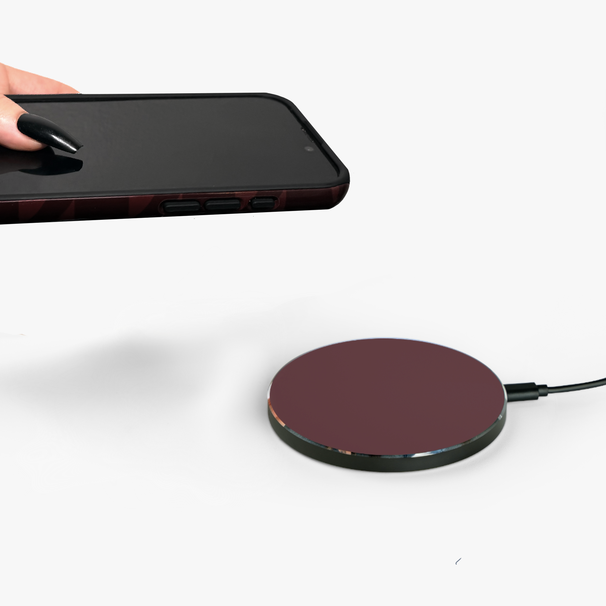 wireless charger red with phone case being placed down by model
