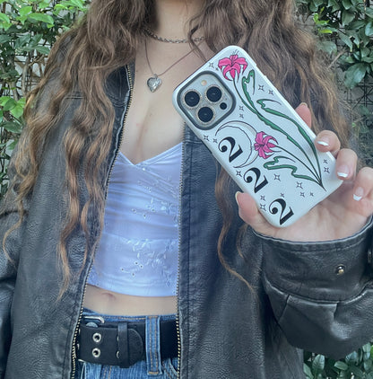 Magsafe Phone case with pink lilies, moon, 222 angel number on white background. Cute, aesthetic, protective design. Fits iPhone, Samsung & Google Pixel models. modeled