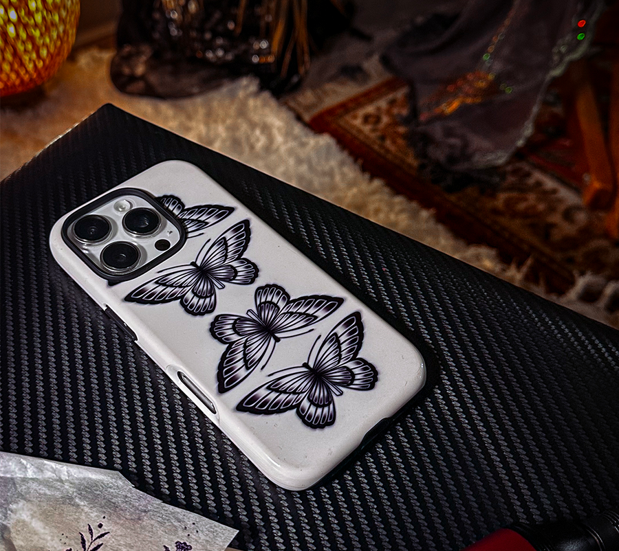 Phone case with butterfly design on a textured surface