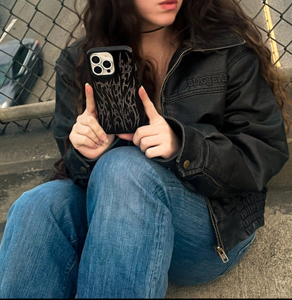 metal cyber cigilism black phone case with chrome silver daggers, protective and edgy held by model in leather jacket