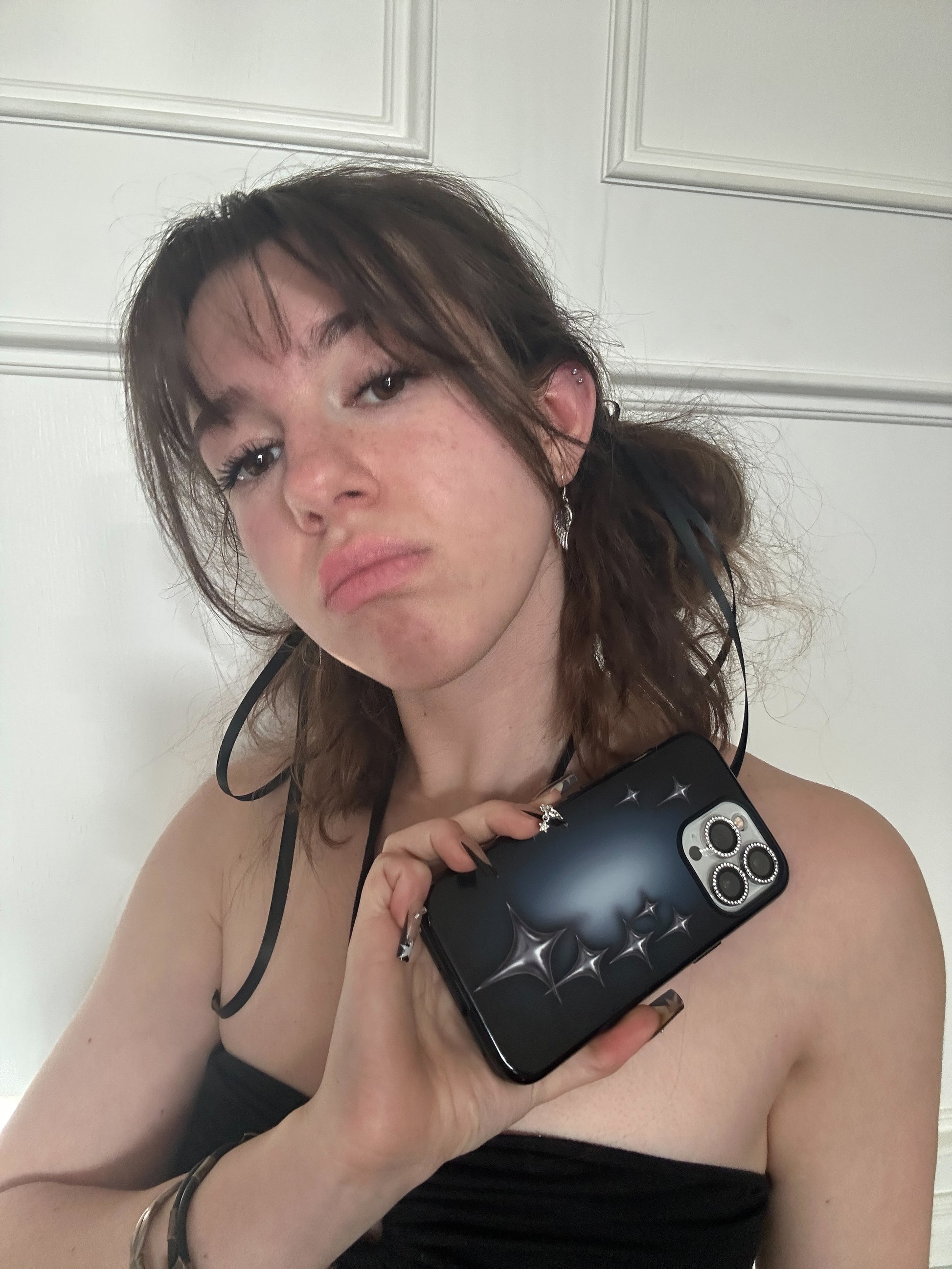 phone case with chrome star design on blue black background. Protective & shock-absorbing. Fits iPhone, Samsung & Google Pixel models. Cool, edgy design model closeup pose