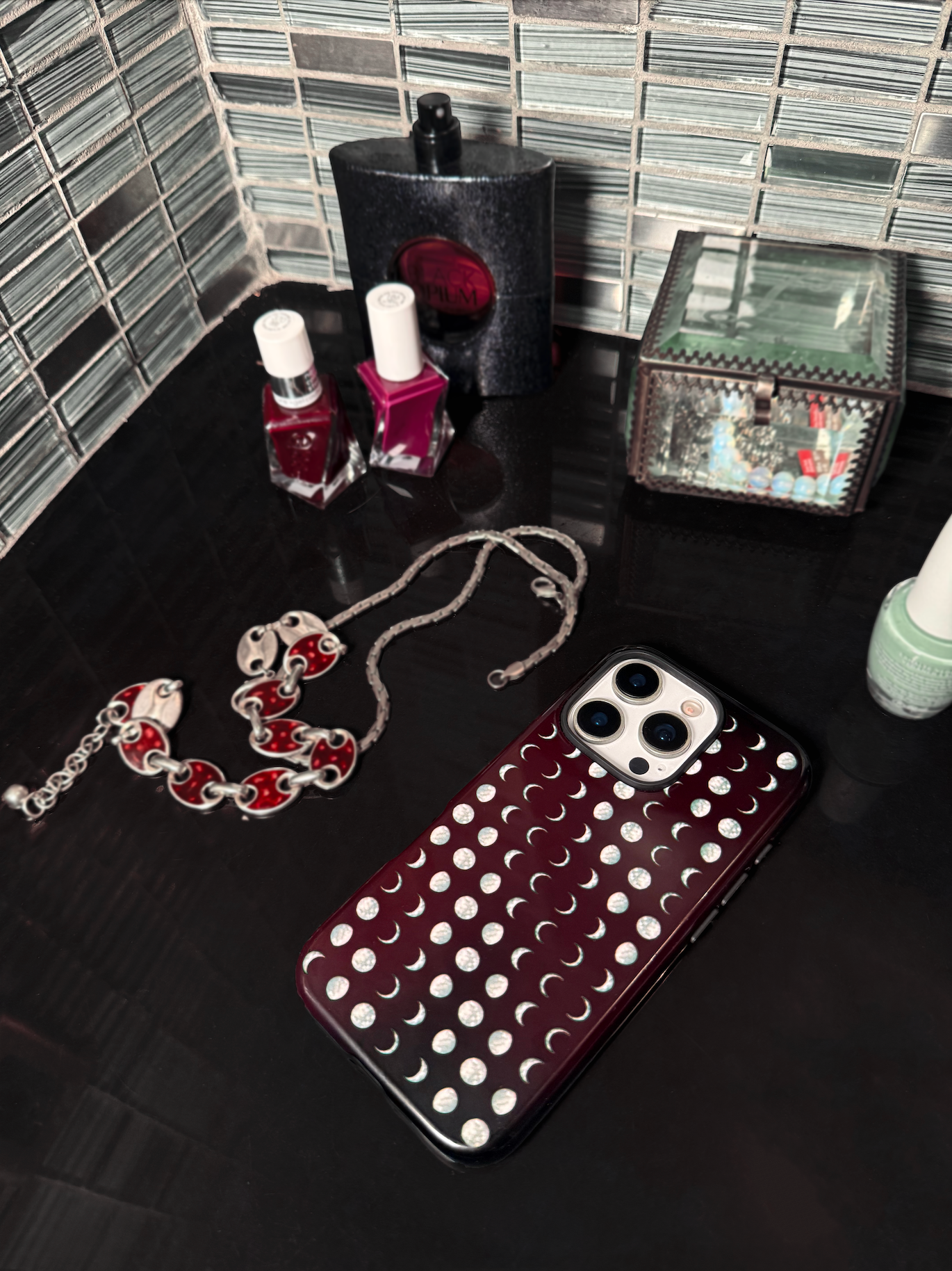dark red phone case with sage green moons protective on iPhone 16 pro in bathroom matches cool girl indie sleaze boho chic whimsy goth aesthetics